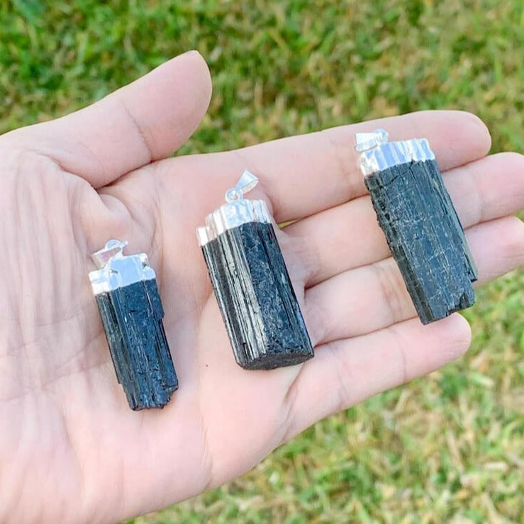 Check out our Raw Black Tourmaline Crystal Pendant Silver Necklace. The Best Quality Handmade Healing Crystal Gemstones for Protection. This is a Great Stone to Keep you grounded and Align your Root Chakra. Black Tourmaline Also Aids in the Removal of Negative Energies Within a Person or a Space. Magic Crystal Free Shipping Available.