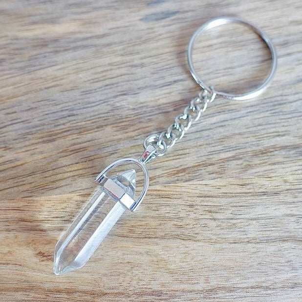 Clear Crystal Quartz keychain. Shop at Magic Crystals for Crystal Keychain, Pet Collar Charm, Bag Accessory, natural stone, crystal on the go, keychain charm, gift for her and him. Clear Crystal Quartz is a great for all hear. Clear Crystal Quartz Natural Stone Keychain, Crystal Keychain, Clear Crystal Quartz Crystal Key Holder. White clear gemstone.