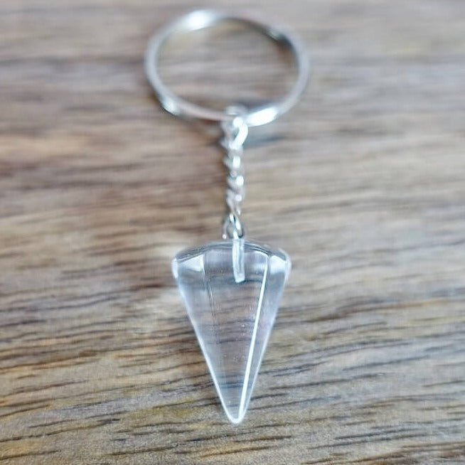 Clear Crystal Quartz keychain. Shop at Magic Crystals for Crystal Keychain, Pet Collar Charm, Bag Accessory, natural stone, crystal on the go, keychain charm, gift for her and him. Clear Crystal Quartz is a great for all hear. Clear Crystal Quartz Natural Stone Keychain, Crystal Keychain, Clear Crystal Quartz Crystal Key Holder. White clear gemstone.