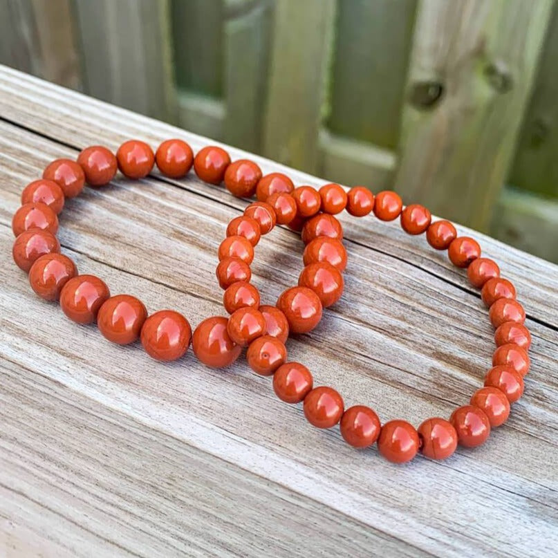 Looking for Red Jasper Jewelry? Shop at Magic Crystals for Red Jasper Beaded Bracelets. Natural Red Jasper Unisex Elastic Bracelet. Red jasper is a stone of physical strength, a vitality that can help with the stabilization of one’s energy. FREE SHIPPING available. Natural Healing Gemstone Buddha Charm Bracelet, red jasper earrings, and rings.