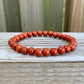 Looking for Red Jasper Jewelry? Shop at Magic Crystals for Red Jasper Beaded Bracelets. Natural Red Jasper Unisex Elastic Bracelet. Red jasper is a stone of physical strength, a vitality that can help with the stabilization of one’s energy. FREE SHIPPING available. Natural Healing Gemstone Buddha Charm Bracelet, red jasper earrings, and rings.