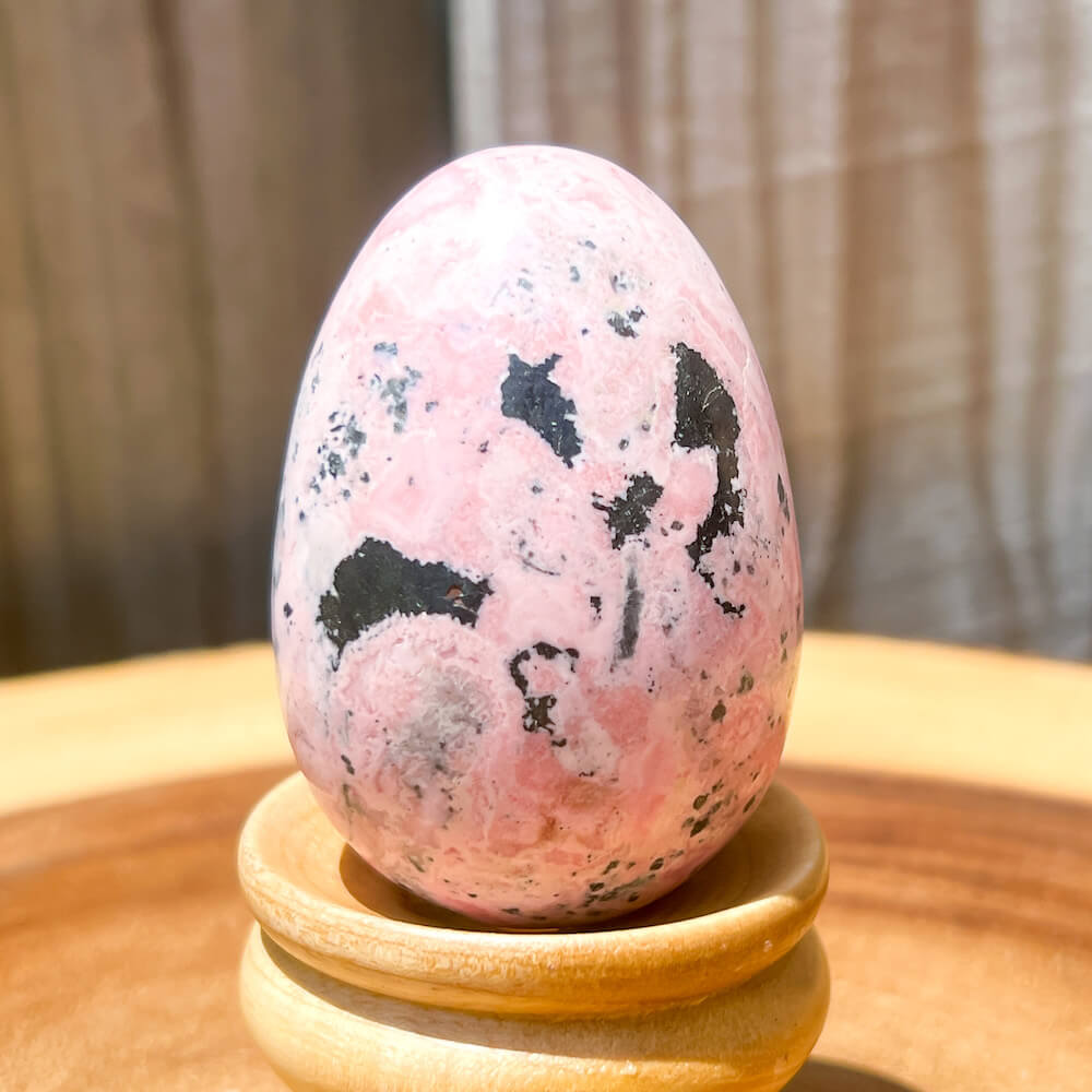 Shop for handmade Pink Rhodonite Egg -  Peruvian Rhodonite Carved Egg at Magic Crystals. Rhodonite Polished Egg Healing Crystal Gemstone. Rhodonite is a wonderfully peaceful crystal. Enjoy FREE SHIPPING when you shop at magiccrystals.com. Undrilled crystal egg. Undrilled Pink Egg.